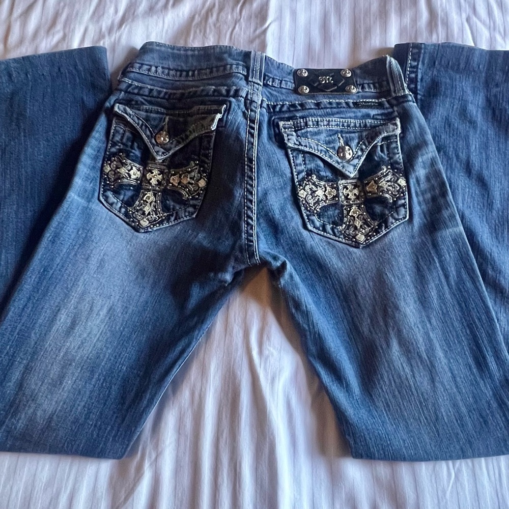 Miss me distressed jeans with cross on back pockets and bling.